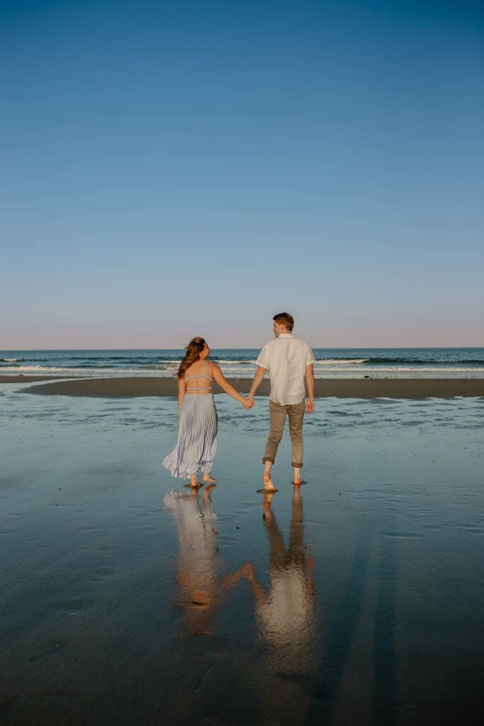Couple posing for engagement photos at Footbridge Beach in Ogunquit Maine.