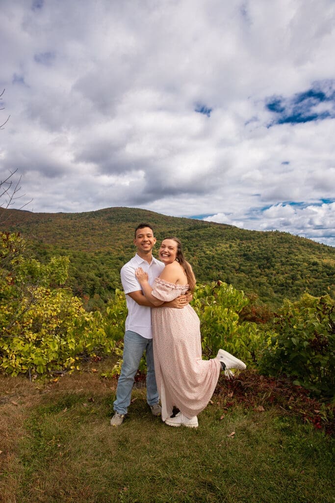 Couple posing for engagement photos at Castle in the Clouds