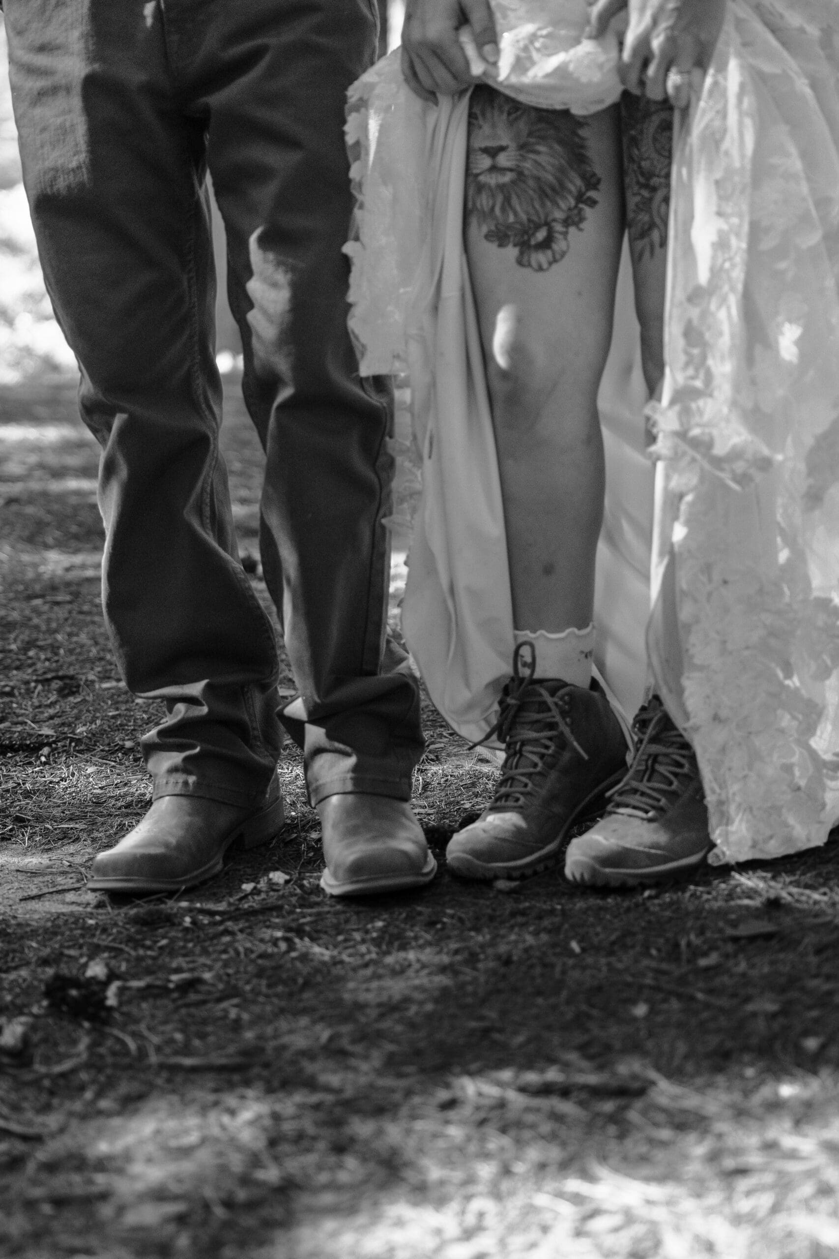 Black and white detail photo of the bride and groom’s boots and wedding attire during their New Hampshire elopement.